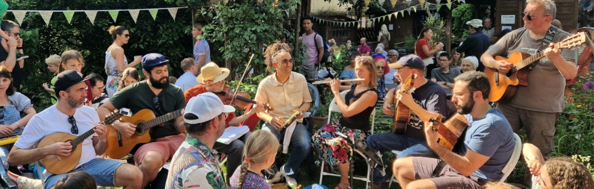 A group of musicians play various instruments surrounded by onlookers