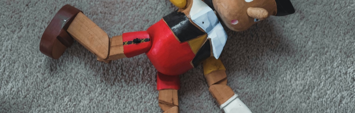 Pinocchio lying on a carpet