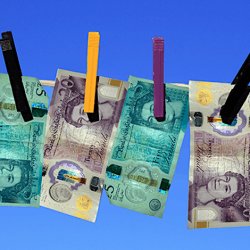 5, 10 and 20 pound notes pinned to a washing line