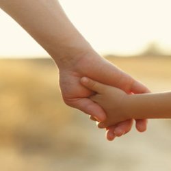 parent holding child's hand