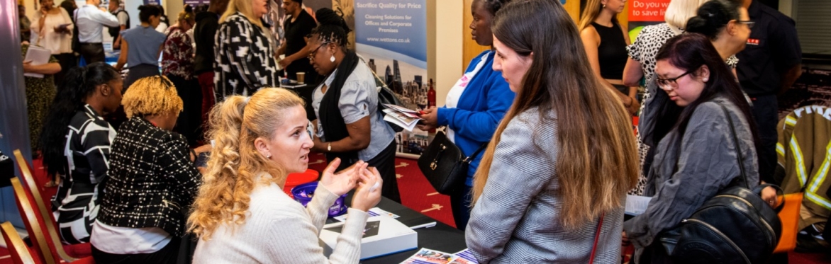 A recruiter talking to an attendee at the 2023 Jobs & Skills Fair