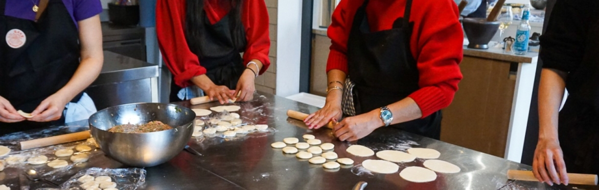 Dumpling Class Participants diligently rolling the dough into wrappers