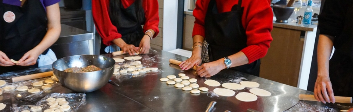 Dumpling Class Participants diligently rolling the dough into wrappers
