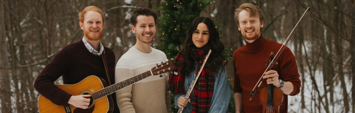 Members of On the Lash standing in snow with backdrop of trees