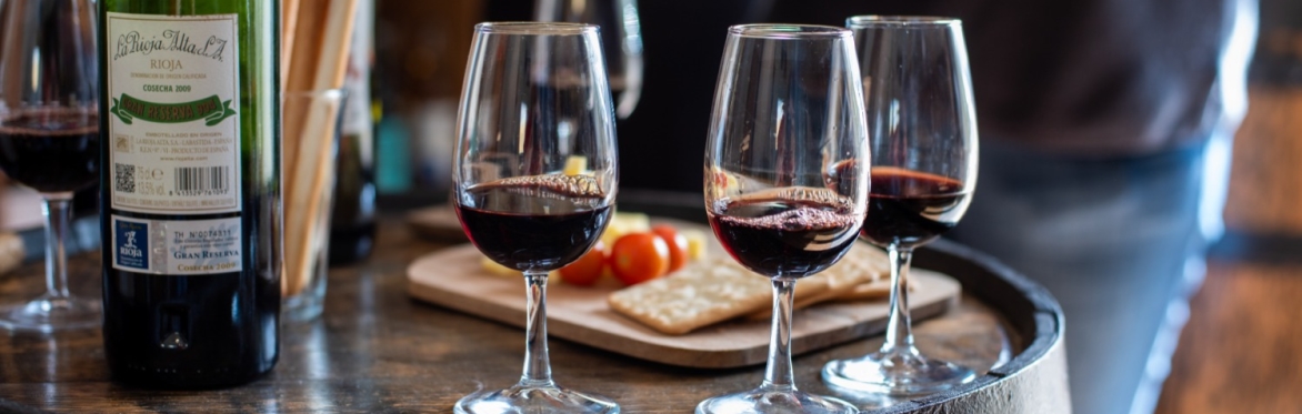 People smiling and drinking wine with each other
