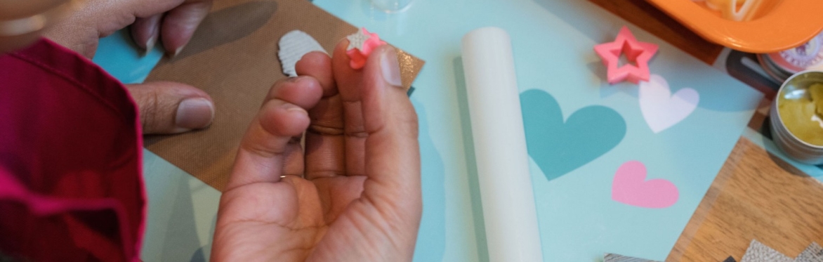Hands cutting out star from metal clay