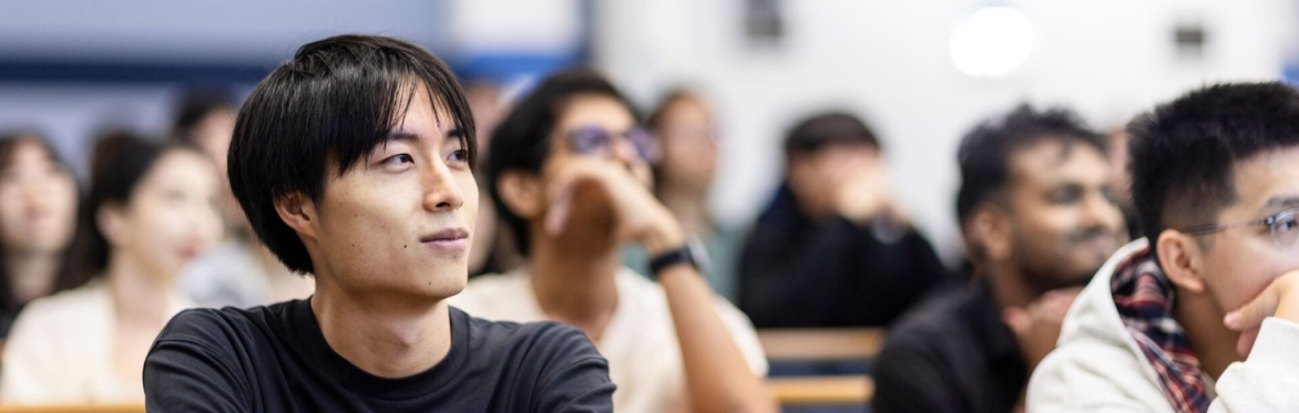 Student seated in lecture theatre