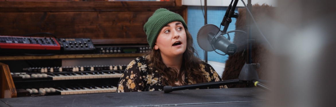 A picture of emma langford playing guitar