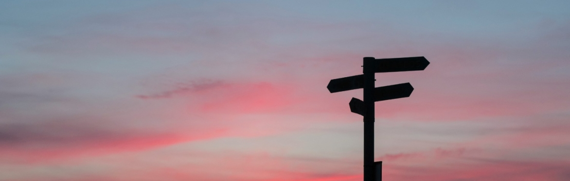 A wooden pier with a sunset