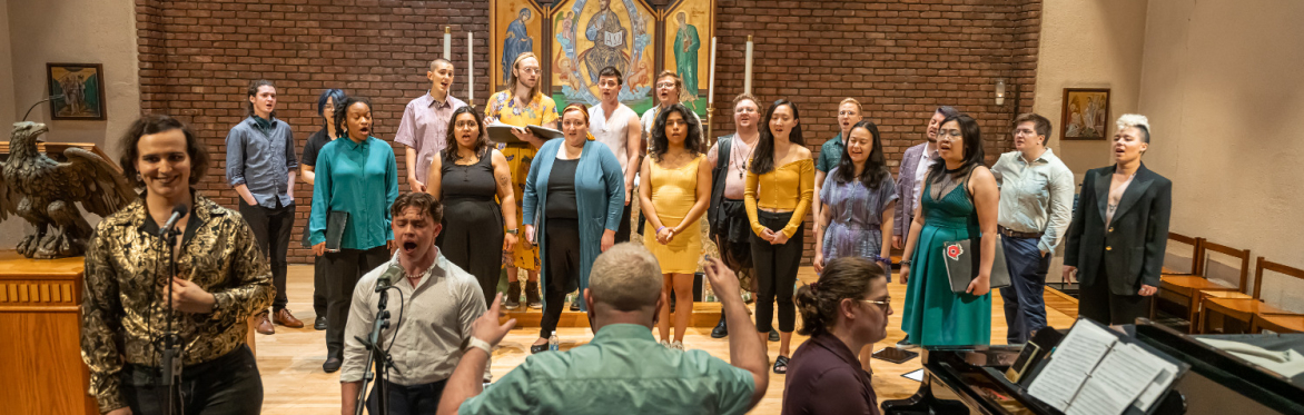 A photo of our choir performing last year at our pride concert