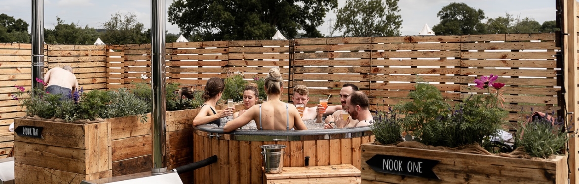 Hot tubs, sauna and seating in a field