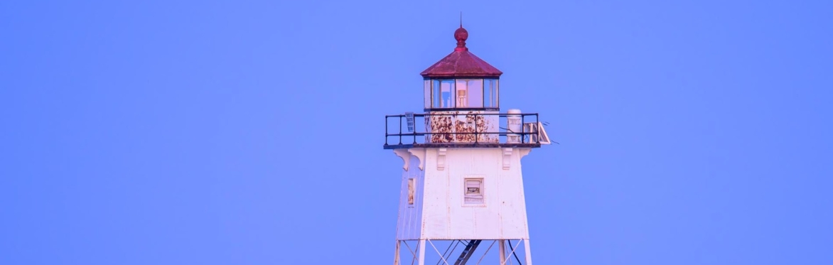 The full moon rising behind the Grand Marais lighthouse.