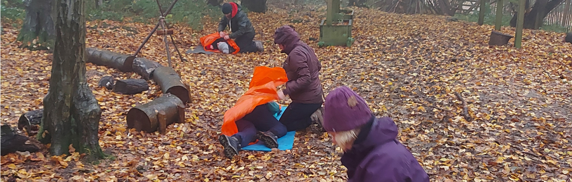 three First Aiders keeping three patients warm when outside