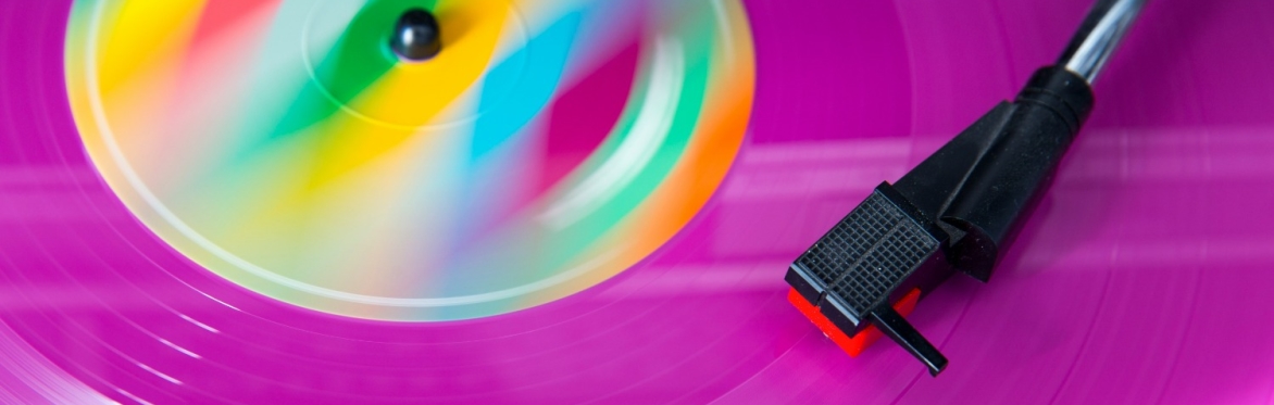Close up of a purple record with a rainbow pattern in the middle