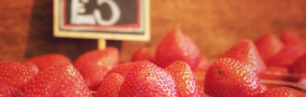 a close up of some strawberries in cups on a market stall - £5 a cup apparently!