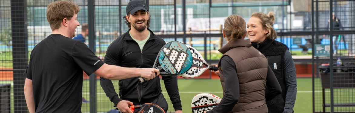 Women holding a padel racket, waiting for a ball