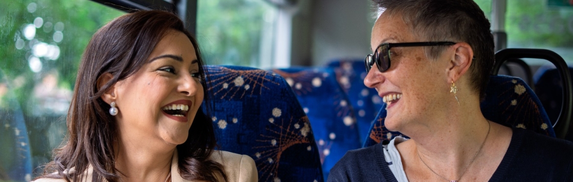 Two people enjoying a chat on the bus