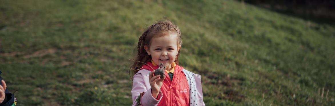 Child with creation in hand - photo by Helen Dolby