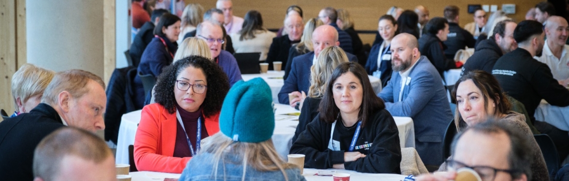 People sat talking at a networking event
