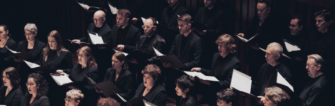 A choir of singers, dressed all in black