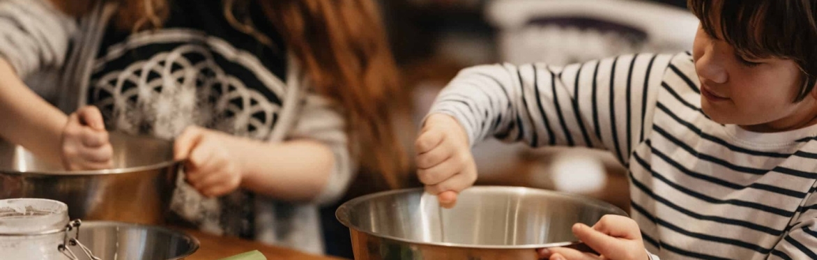 Children stirring in mixing bowls
