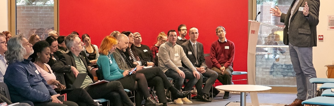 A photograph of speaker and audience from our 2024 Forum.