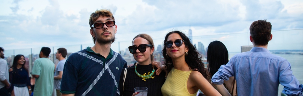 Image of a group of people looking out from the roof at Le Bain onto Manhattan.