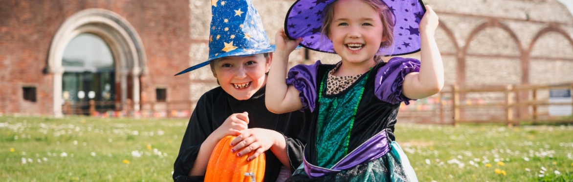Two girls dressed as witches outside Fort Nelson.