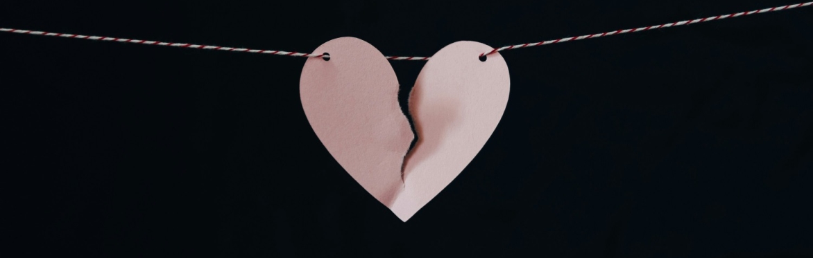 ripped paper heart on a string