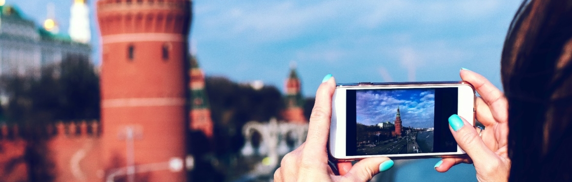 person filming with a smartphone