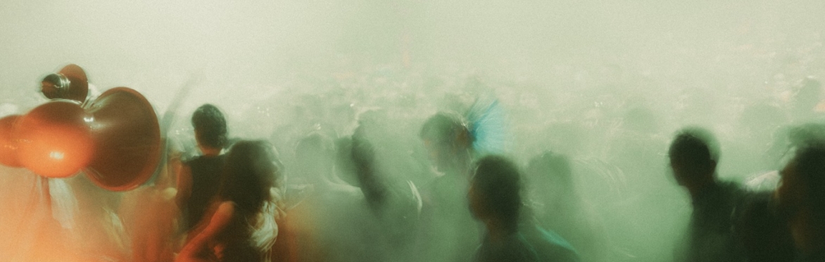 blurry dancefloor photo with people and smoke