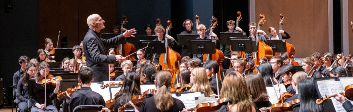 Symphony students stand on stage
