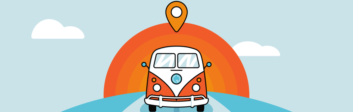 An orange and white VW camper van driving along a road.