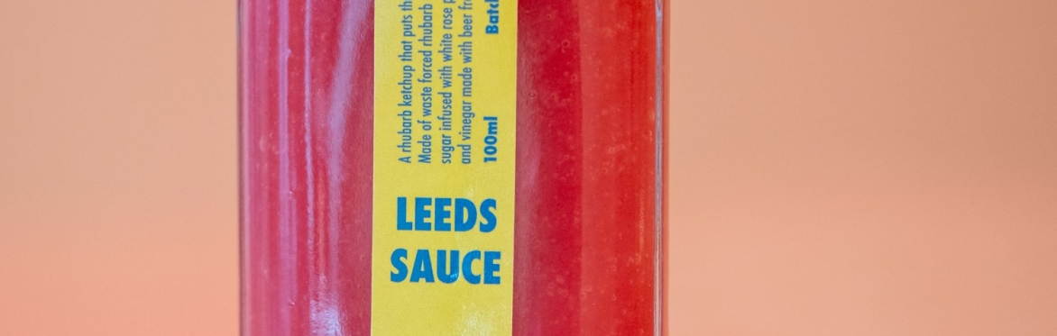 A bright pink bottle with a yellow label reading Leeds Sauce