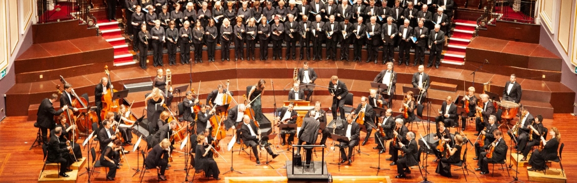 An orchestra setting up on stage