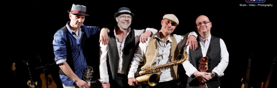 The four-piece band with instruments - lead guitar, drum sticks, saxophone and bass guitar
