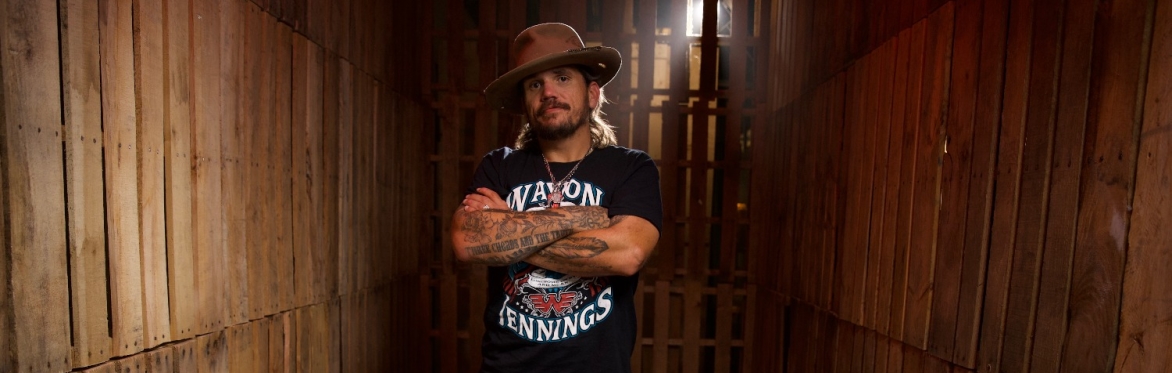 bryan white, music artist wearing a country hat short sleeve shirt and tattoos..