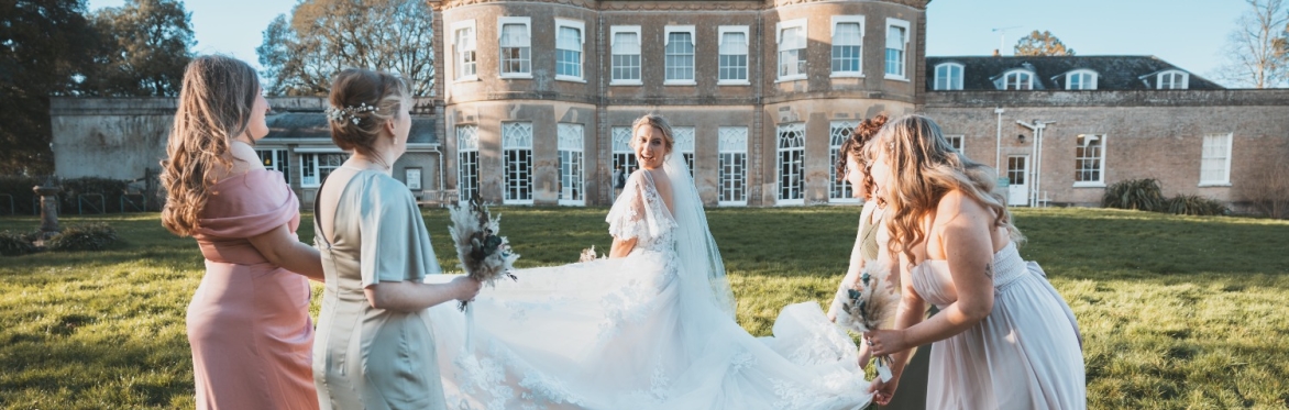 Picture of a Bride and her Bridesmaids in front of  the south side of Upton House