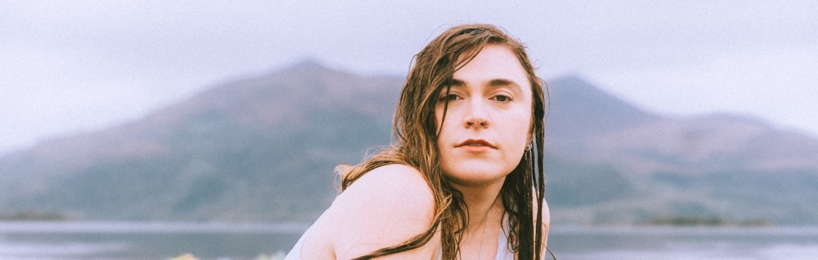 A picture of a lorraine nash in a lake with flowrs