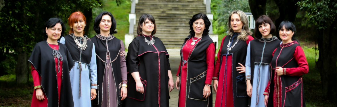 Nanina in traditional dress, standing at the foot of steps
