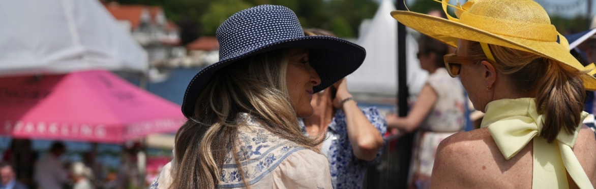 Regatta visitors in colourful straw hats