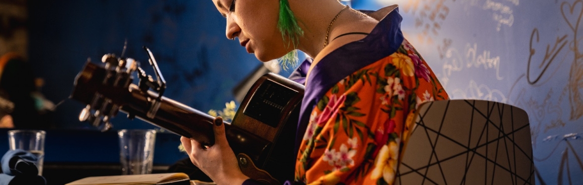 A picture of emma langford playing guitar