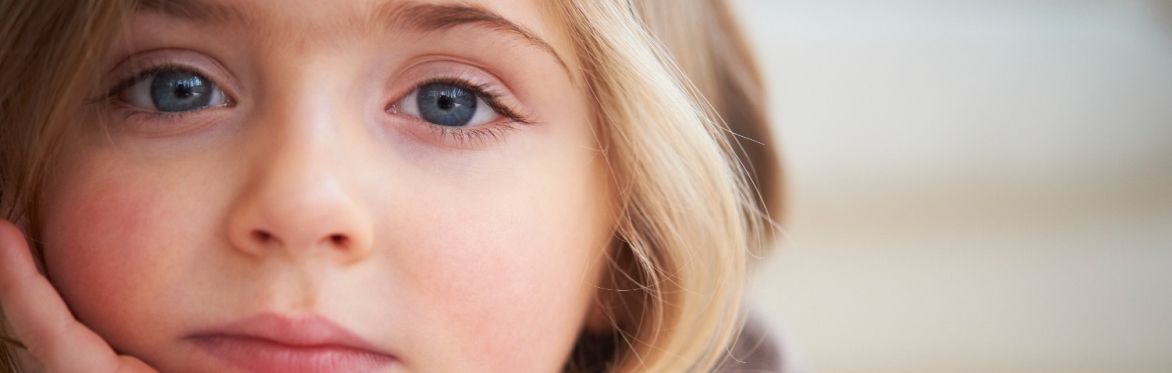 A young girl staring out at the camera
