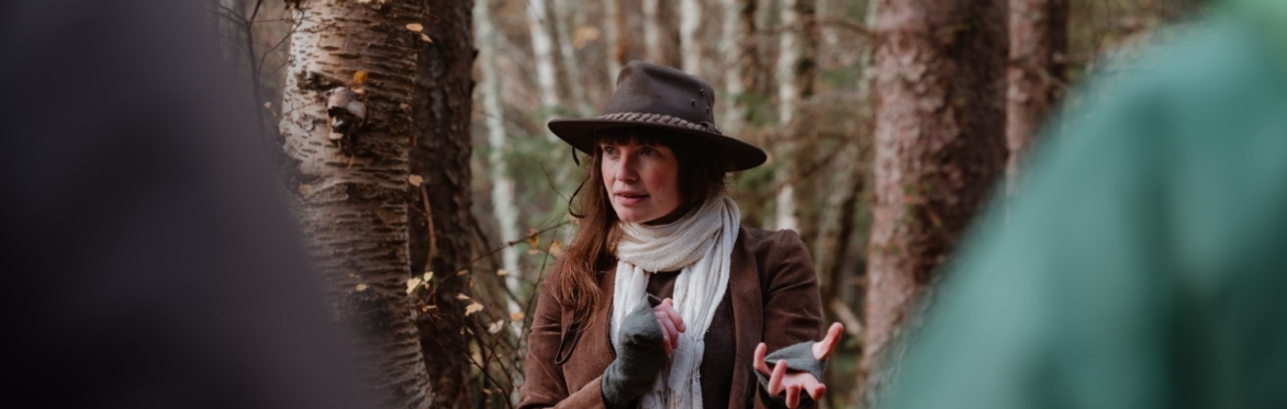Sarah Hobbs telling a story in the woods