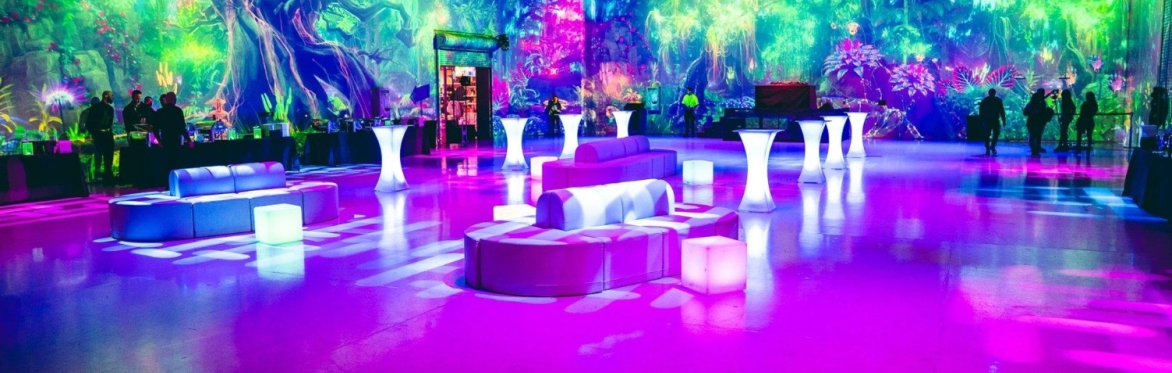 The Portal at AREA15 with colorful immersive wall projections and illuminated lounge seating.