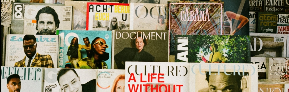 Group of fashion magazines on arrow display arrangement