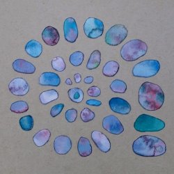 Spiral of blue stone shapes on plain background