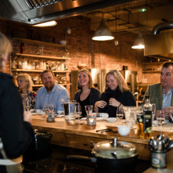 Party of people enjoying a meal and a drink
