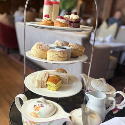 Cake stand with cakes and tea pots and cups