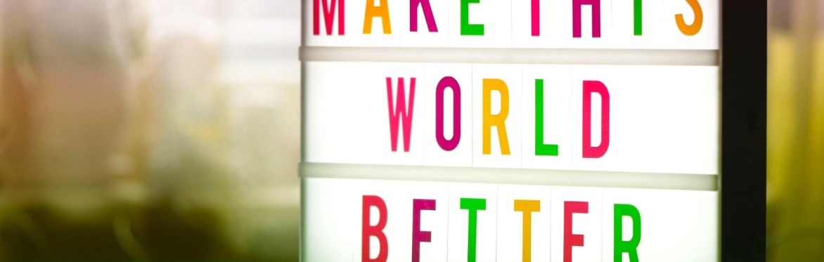 A light box, with colourful letters reading "Make this world better"